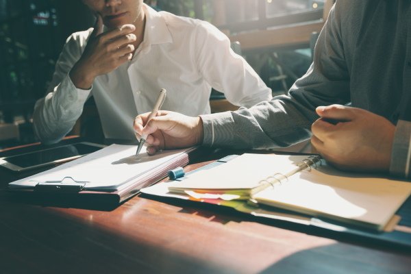 Image of executives drafting a buy-sell agreement